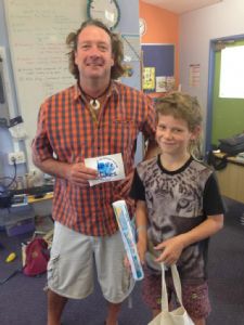 Otis Waratah of Tanja public school receives his artwork prize from Love Our Lakes project officer, Brett Weingarth.