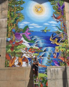 Stan Squire in front of his giant mural in Merimbula.