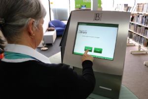 The library’s self-check machine in use. 