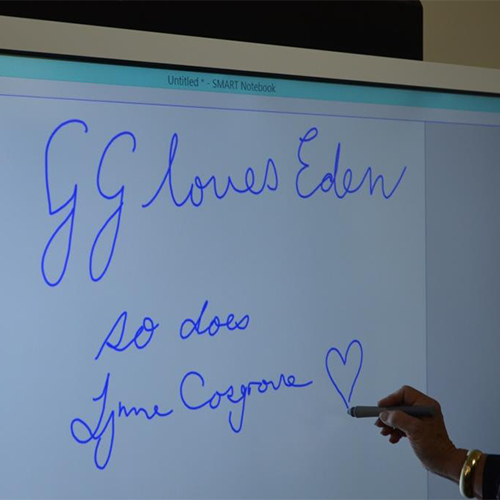 Governor General, Sir Peter Cosgrove, with Lady Cosgrove and children and staff from Eden Childcare Centre. Also, the message written on the classroom smartboard.